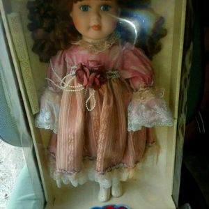 *NEW * Porcelain doll in mauve dress *NEW*
